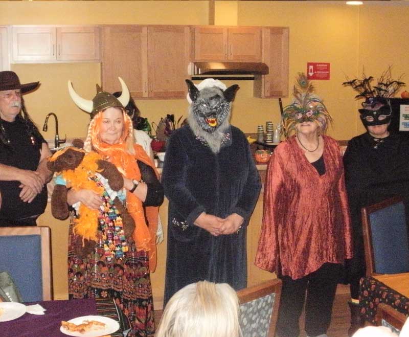 Staff and residents dressed in Halloween costumes.